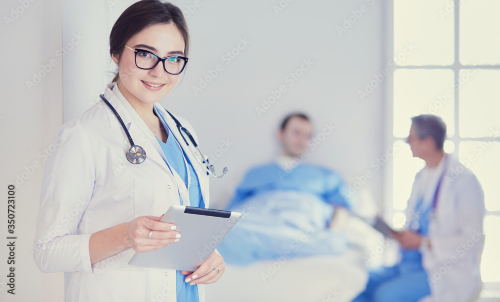 Female doctor using tablet computer in hospital lobby Female doctor using tablet computer in hospital lobby
