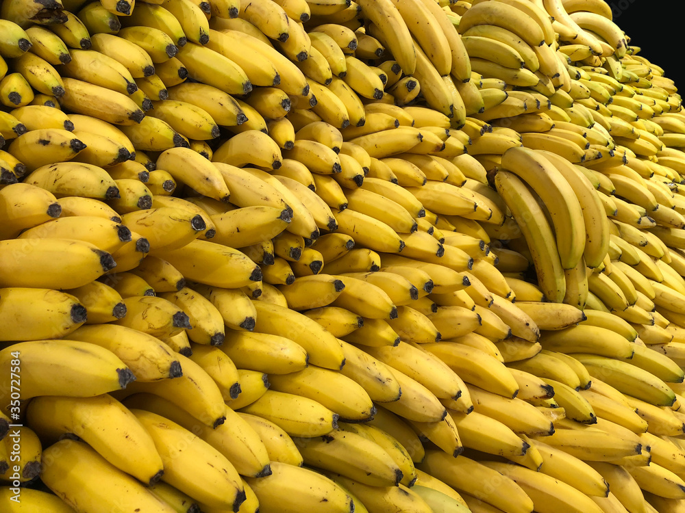Yellow bananas in supermarket, food and retail concept