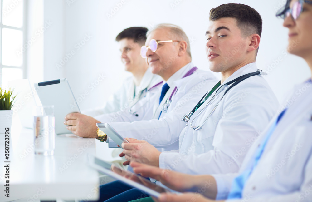 Medical team sitting and discussing at table Medical team sitting and discussing at table