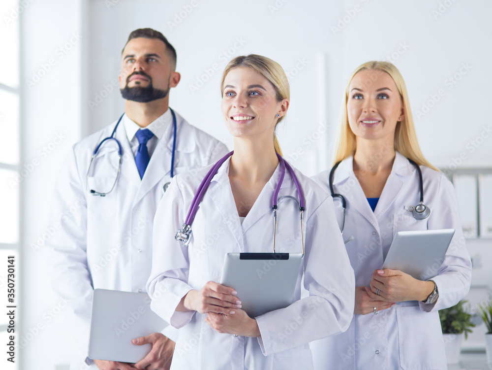 Smiling doctors all standing together as they work Smiling doctors all standing together as they work