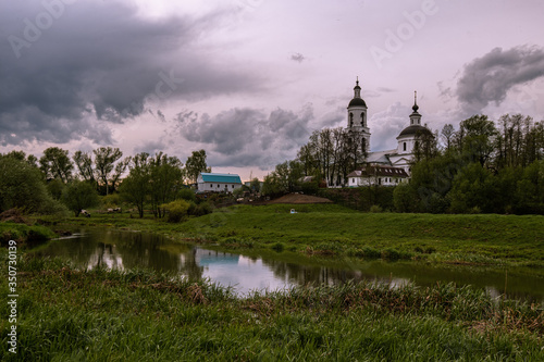 Orthodox Church by the river in the evening sunset