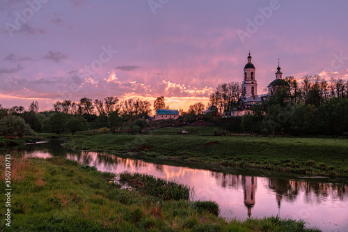 Orthodox Church by the river in the evening sunset