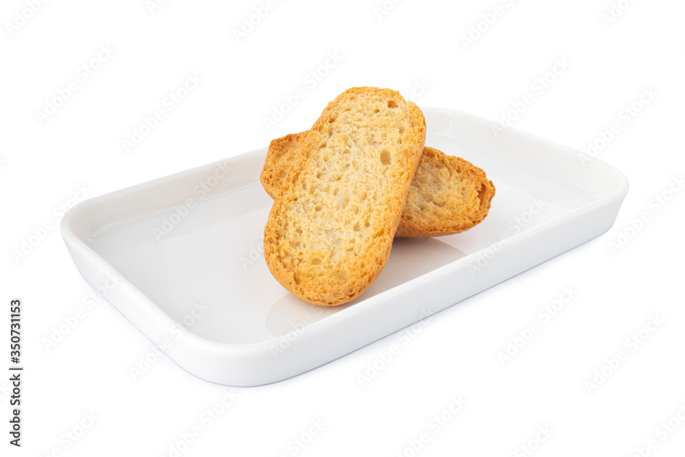 Obraz premium Double crispy biscottes, french toast bread on white plate, on white background 