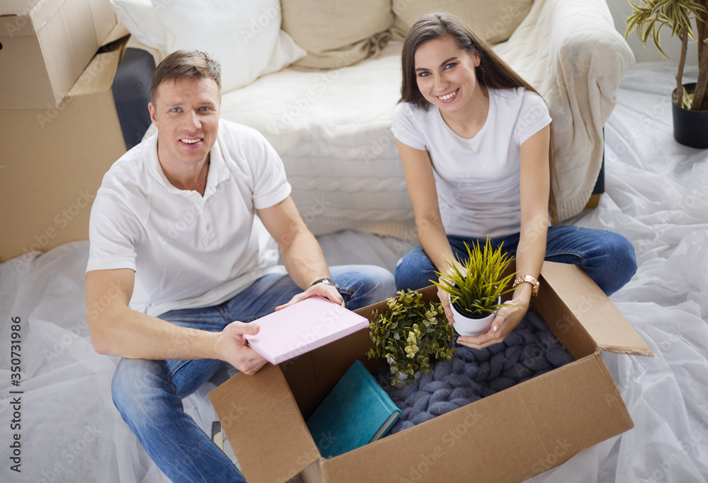 Portrait of young couple moving in new home. Top vIew