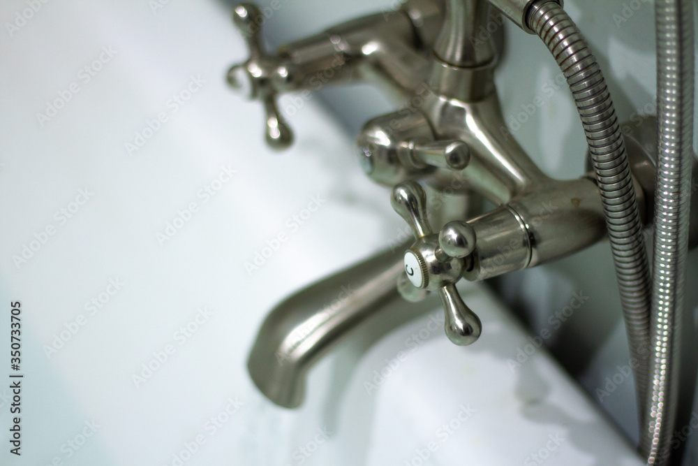 Running a bath at home, preparing for a relaxing evening in. Running a bath at home, preparing for a relaxing evening in.