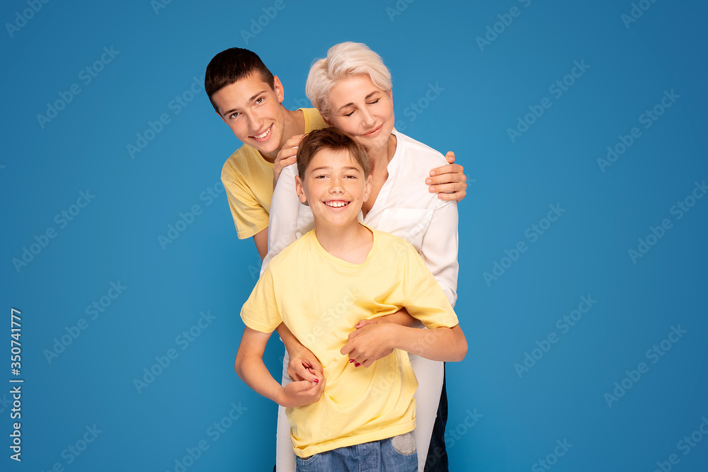 Mother with two sons posing in studio.Mother's day. Mother with two sons posing in studio.Mother's day.