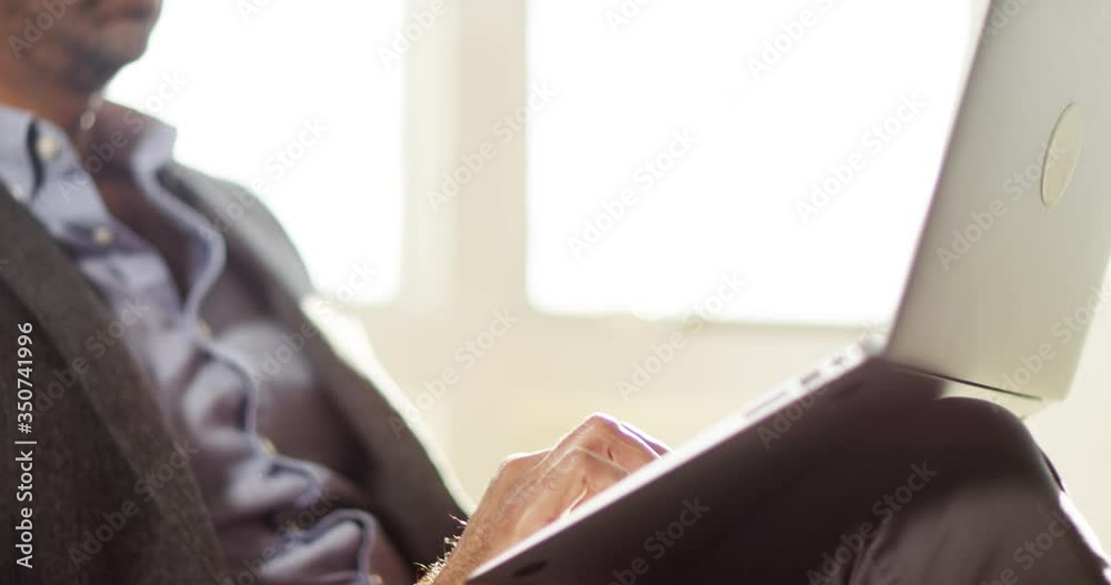 4k shot of a handsome young businessman working at home