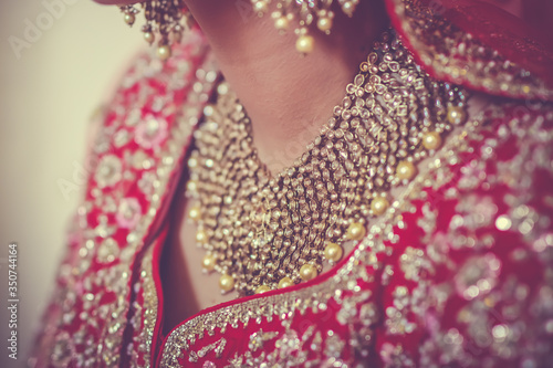 Indian Punjabi Sikh bride is wearing her jewellery close up