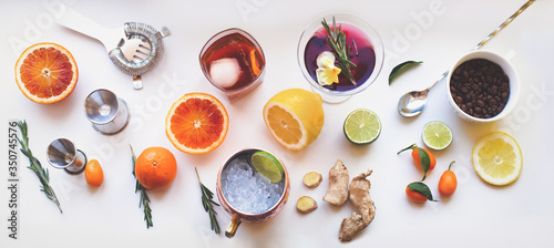 Home made cocktails ingredients blood orange lemon lime ginger herbs and martini Moscow mule cocktails on white background. Backdrop for social media network blogs drink recipe posts
