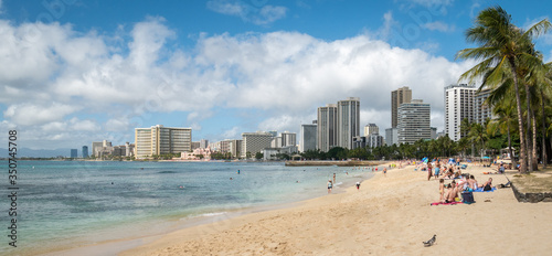 Busy sandy beach with hotels and resorts, shot on Waikiki Beach, Honolulu, Hawaii, USA