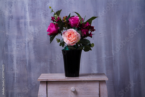 bouquet of roses in a vase. artificial flower photo
