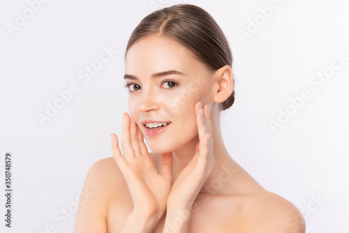 Beautiful Young Woman touching her clean face with fresh Healthy Skin, isolated on white background, Beauty Cosmetics and Facial treatment Concept