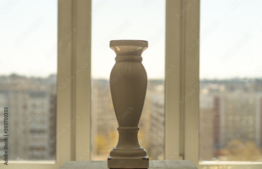 Greek style vase in front of a window with blurry background Stock