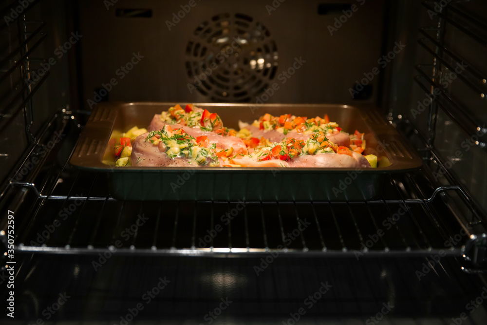 Stuffed chicken breast fillet, baked with vegetables in the oven. Cooking home-made dishes for a holiday. Recipe book. Stuffed chicken breast fillet, baked with vegetables in the oven. Cooking home-made dishes for a holiday. Recipe book.