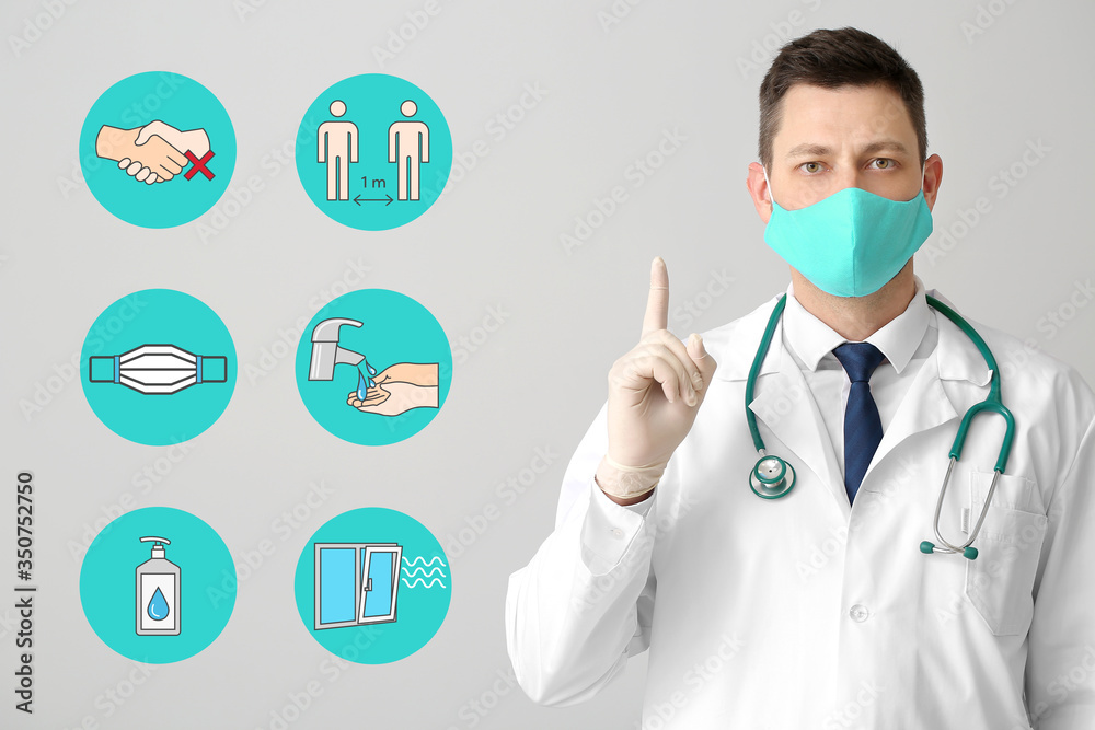 Doctor in protective medical mask and with tips for social distancing on grey background Doctor in protective medical mask and with tips for social distancing on grey background