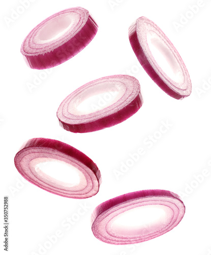 Foto Flying onion rings on white background