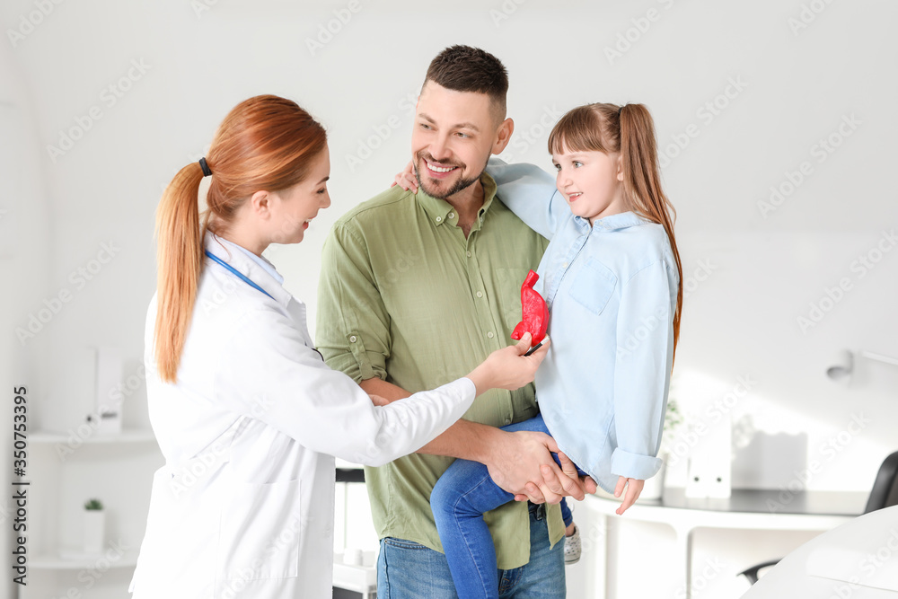 Fototapeta premium Man with his little daughter visiting gastroenterologist in clinic