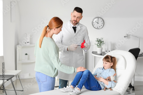 Woman with her little daughter visiting gastroenterologist in clinic