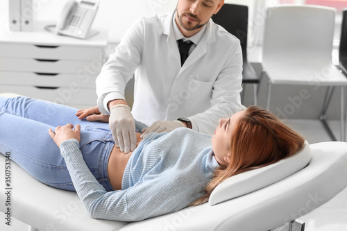 Gastroenterologist examining woman in clinic photo