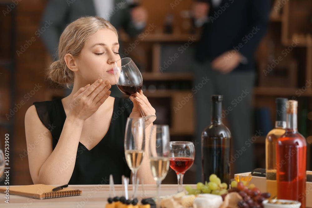 Woman tasting wine at the restaurant Woman tasting wine at the restaurant