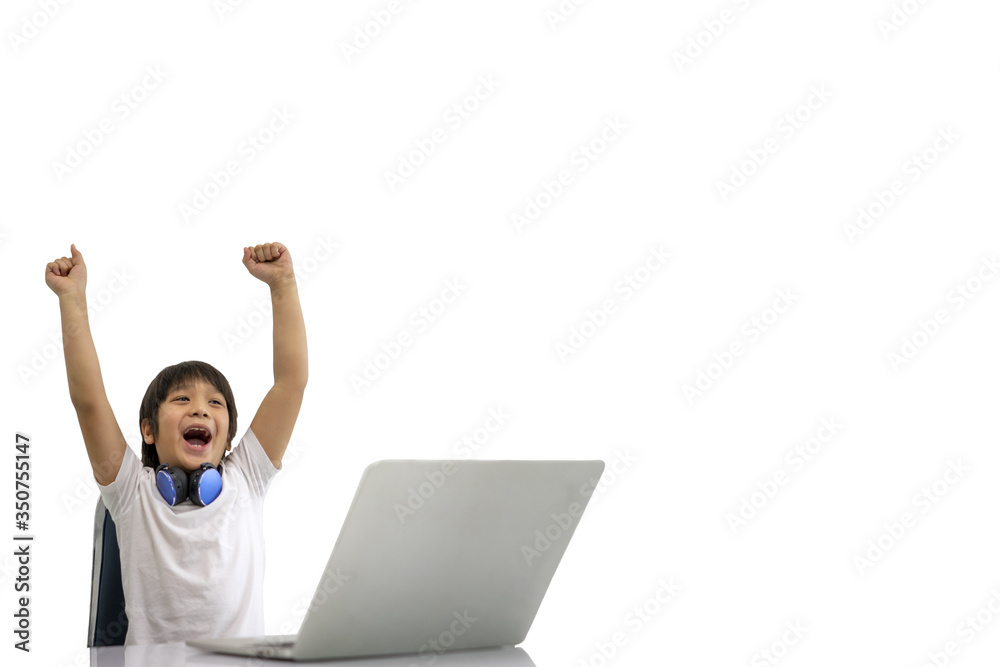 Cute boy playing laptops along with raised arms. White Background. Distance education. Network and connection. Children and learning concept. Concept of Studying at home and Technology. Cute boy playing laptops along with raised arms. White Background. Distance education. Network and connection. Children and learning concept. Concept of Studying at home and Technology.