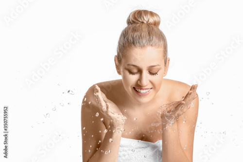 Woman washing face against ...