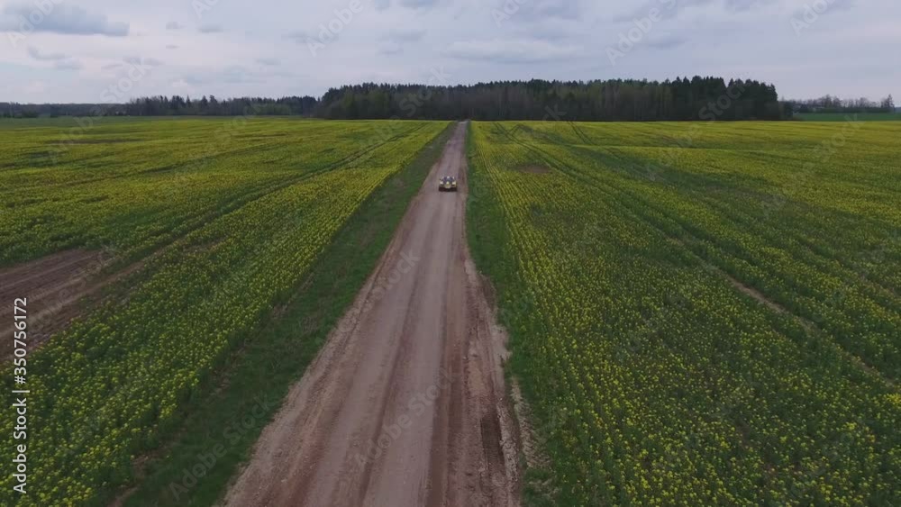 Yellow With Black Stripes Classic Ford Consul Rides On A Gravel Road. 4K Aerial Footage Yellow With Black Stripes Classic Ford Consul Rides On A Gravel Road. 4K Aerial Footage