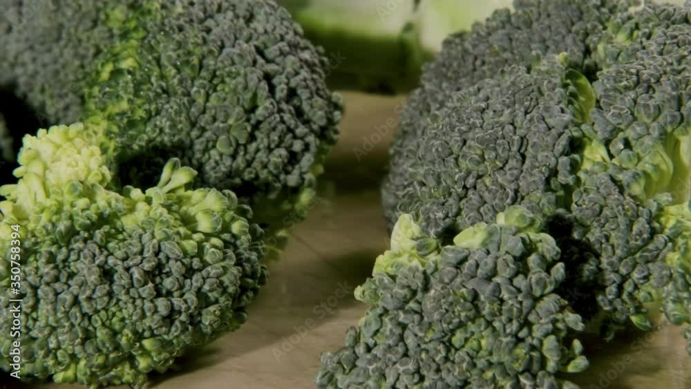 Close-up of raw broccoli showing the detail of the green florets and buds. Close-up of raw broccoli showing the detail of the green florets and buds.