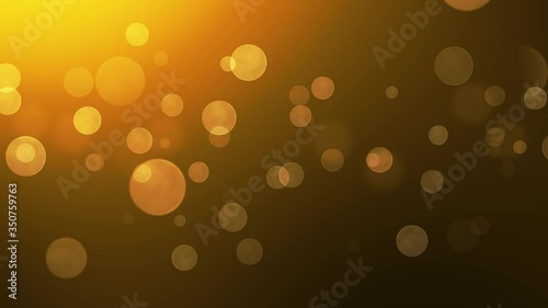 Abstract circular golden sparkle glitter bokeh with a warming background color