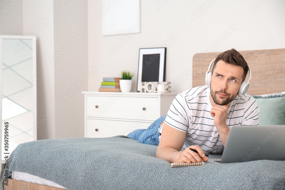 Young man with laptop working at home Young man with laptop working at home
