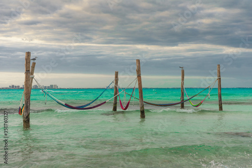 Hammocks hang on poles in the Caribbean. Mexico.