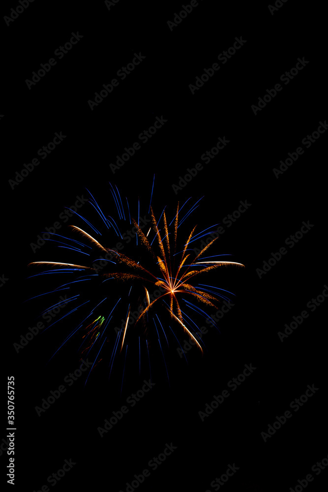 Fototapeta premium Explosive colorful fireworks display celebrating the fourth of July holiday leaving room for copy..