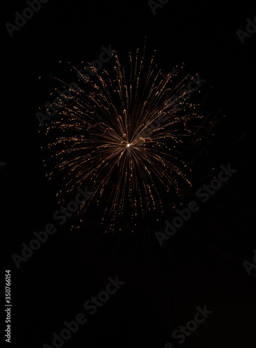 Explosive colorful fireworks display celebrating the fourth of July holiday leaving room for copy..