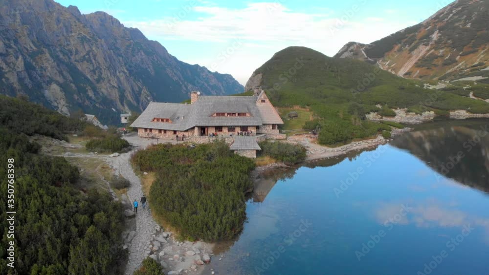 Aerial view of Refugio Shelter in Tatra Mountains in Poland. Drone flying away Revealing the scenery over Beautiful Blue Lake in Tatras National Park, Valley of Five Lakes Aerial view of Refugio Shelter in Tatra Mountains in Poland. Drone flying away Revealing the scenery over Beautiful Blue Lake in Tatras National Park, Valley of Five Lakes