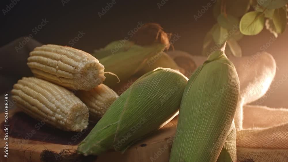 Three corns stacked on top of a wooden board