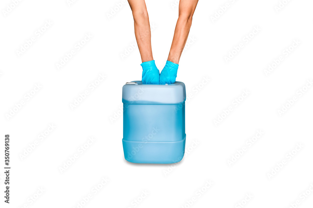 Hand with blue latex examination glove holding gallon bottle of blue alcohol hand spray refill isolated on white background - coronavirus and covid-19 prevention concept. Hand with blue latex examination glove holding gallon bottle of blue alcohol hand spray refill isolated on white background - coronavirus and covid-19 prevention concept.
