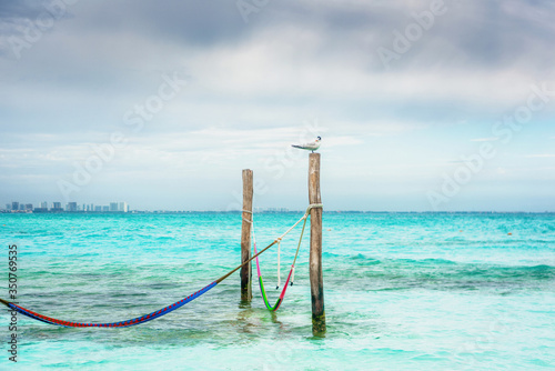 Hammocks hang on poles in the Caribbean. Mexico.