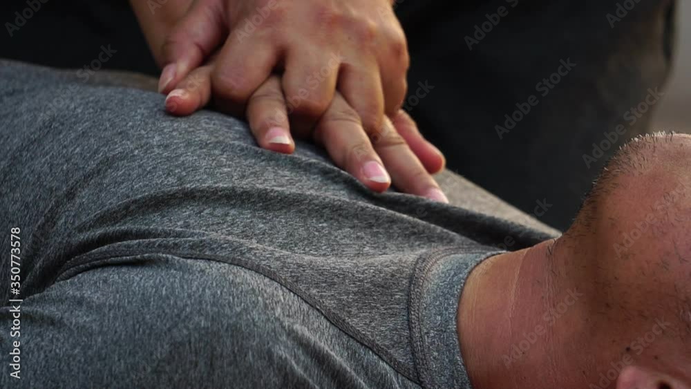 footage 4K: Female doing cardiopulmonary resuscitation to male 