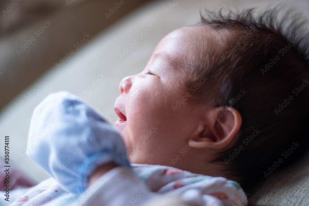 The adorable cute newborn baby infant lying on the bed The adorable cute newborn baby infant lying on the bed