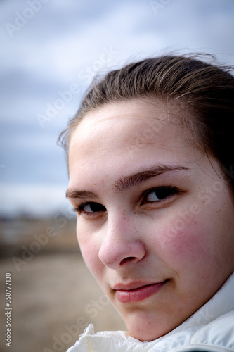 Portrait of Caucasian young woman alone on beach. 