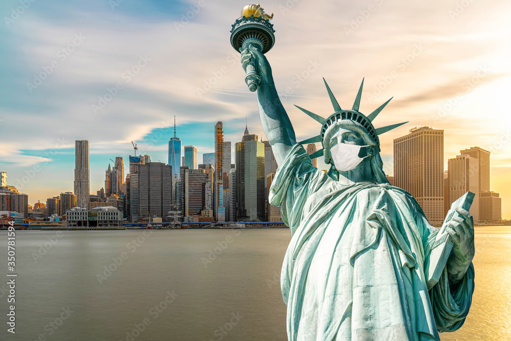 Fototapeta premium The Statue of Liberty wearing surgical mask when Covid-19 Outbreak over the Scene of New york cityscape river side