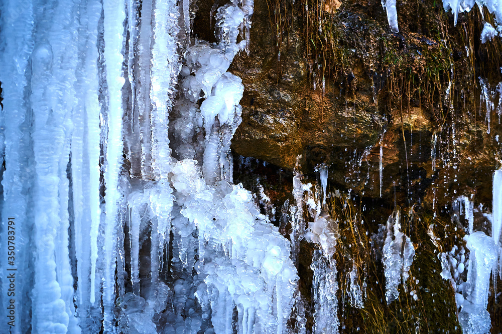 Icicles on the rock. Frozen waterfall in winter. Icicles on the rock. Frozen waterfall in winter.