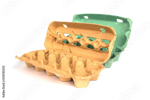 Obraz na plátne Close up of biodegradable egg box made recycled paper with composite additives as straw, leaves, petals, scobs isolated on white background with copyspace, mockup