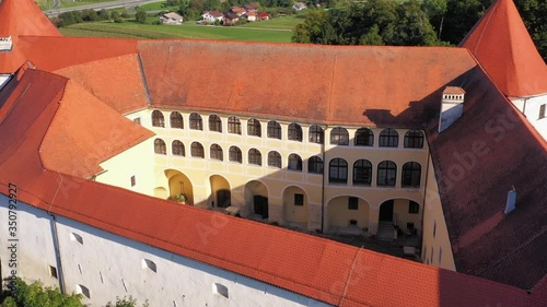 The courtyard of majestic castle in Mokrice. Aerial backward photo