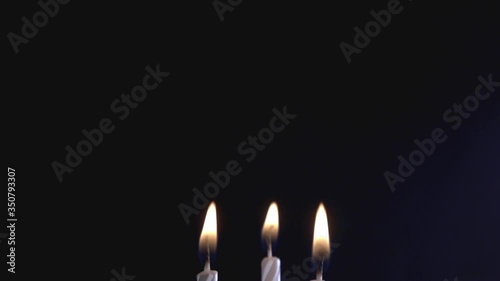 Three Candle Lights Glowing In The Dark. - close up shot photo