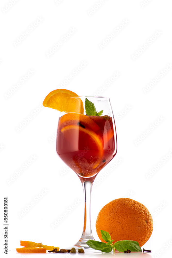 sangria or mulled wine cocktail in a glass with oranges, wine and juice on a white background sangria or mulled wine cocktail in a glass with oranges, wine and juice on a white background