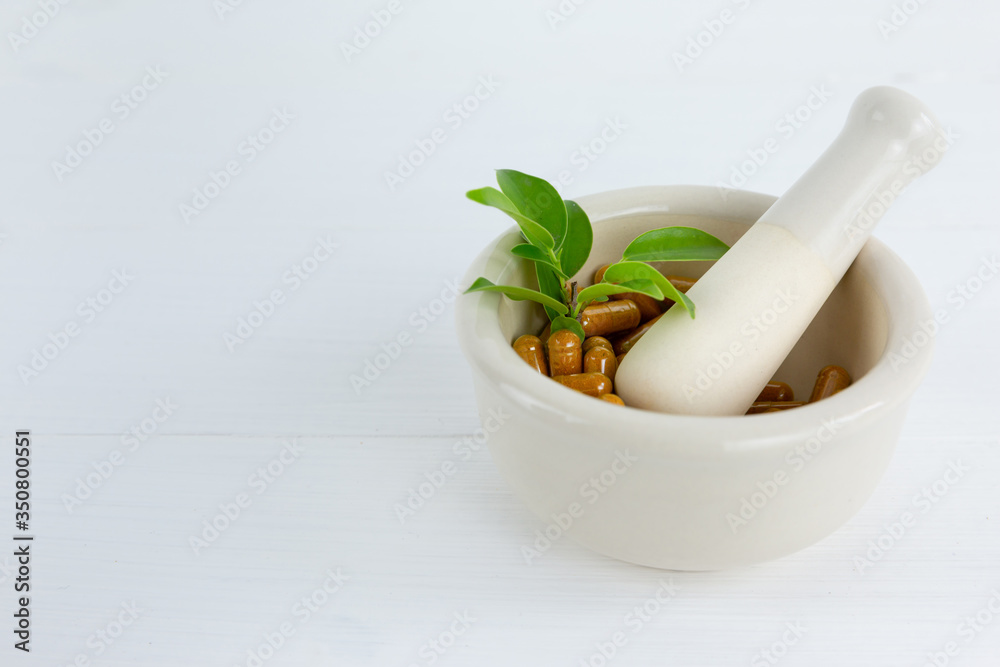Herbal supplement in capsules with healthy medicinal plant.Alternative drug or natural pharmaceutical capsule.Medication of vitamin supplemental for care and treatment. Herbal supplement in capsules with healthy medicinal plant.Alternative drug or natural pharmaceutical capsule.Medication of vitamin supplemental for care and treatment.