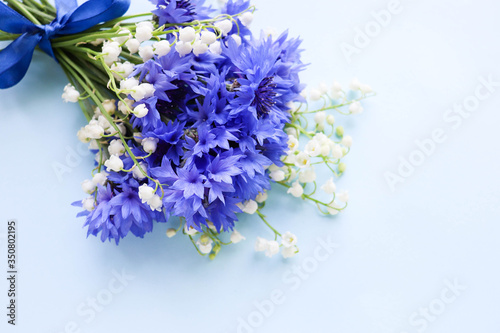 postcard mockup. a bouquet of blue cornflowers and space for text. invitation. congratulation