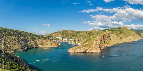 Scenic panoramic view of Balaclava bay with yachts from the ruines of Genoese fortress Chembalo. Balaklava, Sevastopol, Crimea. Inspirational travel landscape. Aerial photo. Copy space. photo