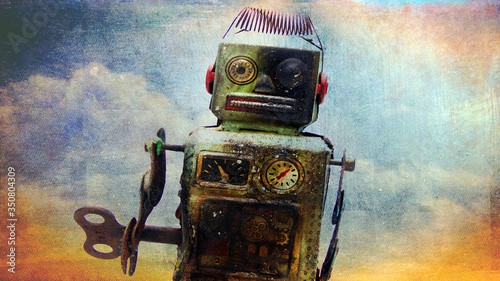 a beat-up robot with clod background 